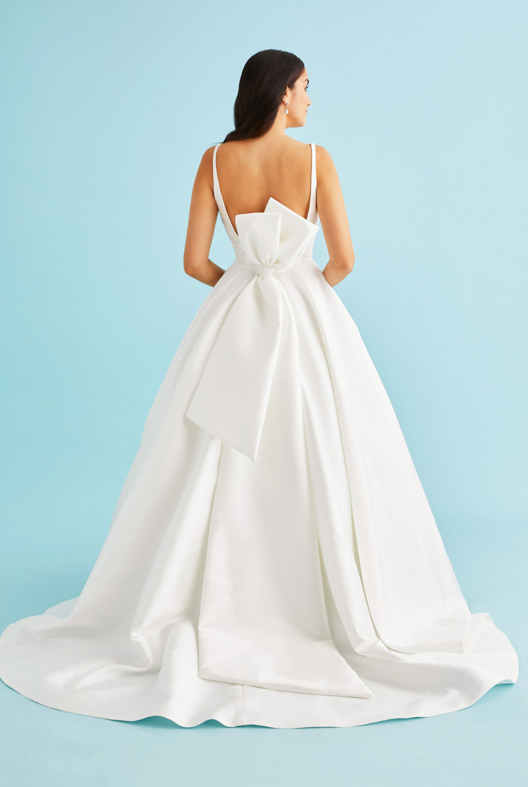 Back view of Brielle revealing the showstopping extravagant vertical bow that creates dramatic dimension and movement against the smooth mikado fabric, complementing the clean lines of this Lea-Ann Belter Toronto wedding dress.