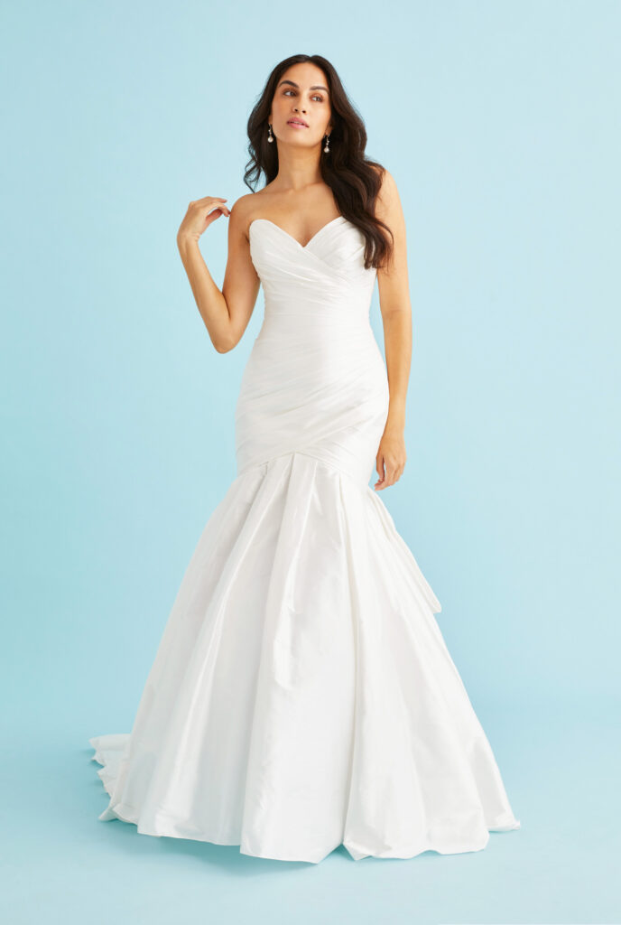 Front view of Tamsyn silk dupioni mermaid wedding dress featuring a ruched sweetheart bodice that contours the figure before flaring into an elegantly pleated skirt with dramatic silhouette handcrafted in Toronto.