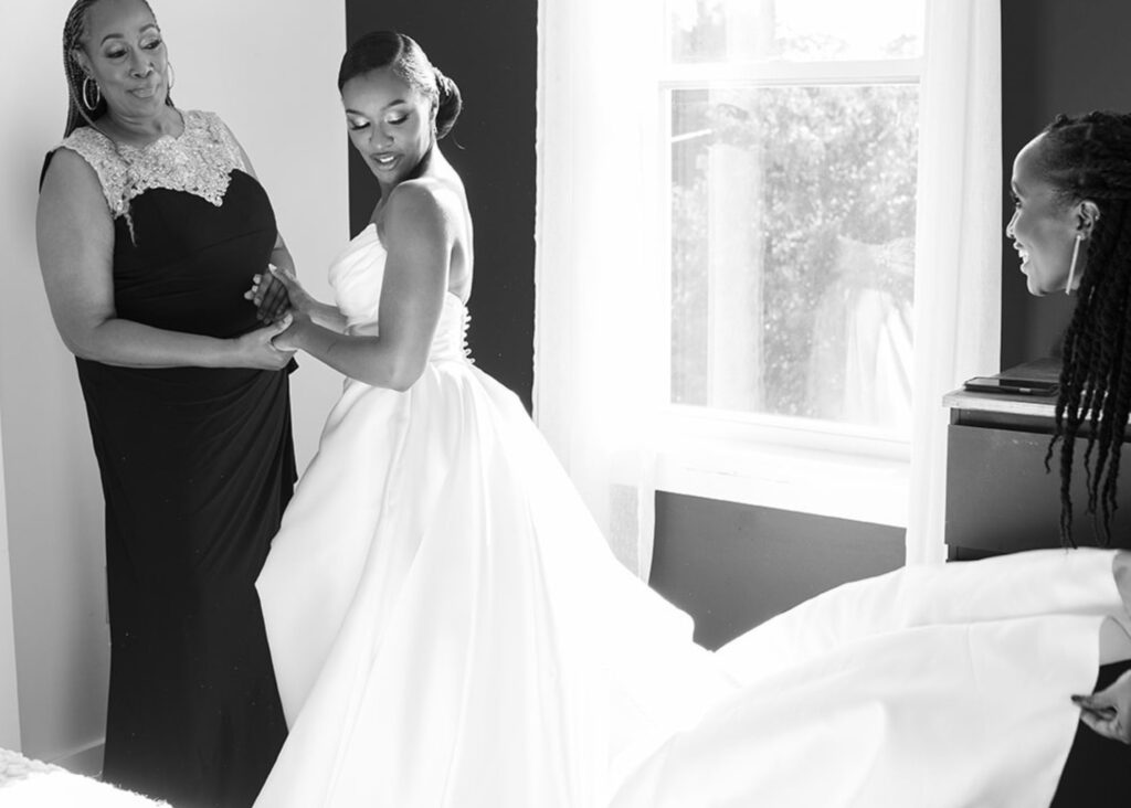 Khadija getting ready on her wedding day with her mom and sister. Khadija is wearing her ball gown wedding dress by Lea-Ann Belter Bridal