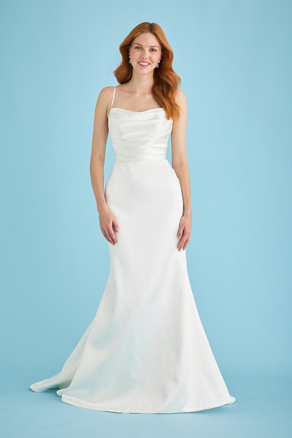 Bride facing forward in the Lila glamorous wedding dress with a draped satin bodice, sleek fit-and-flare silhouette, and flowing train.