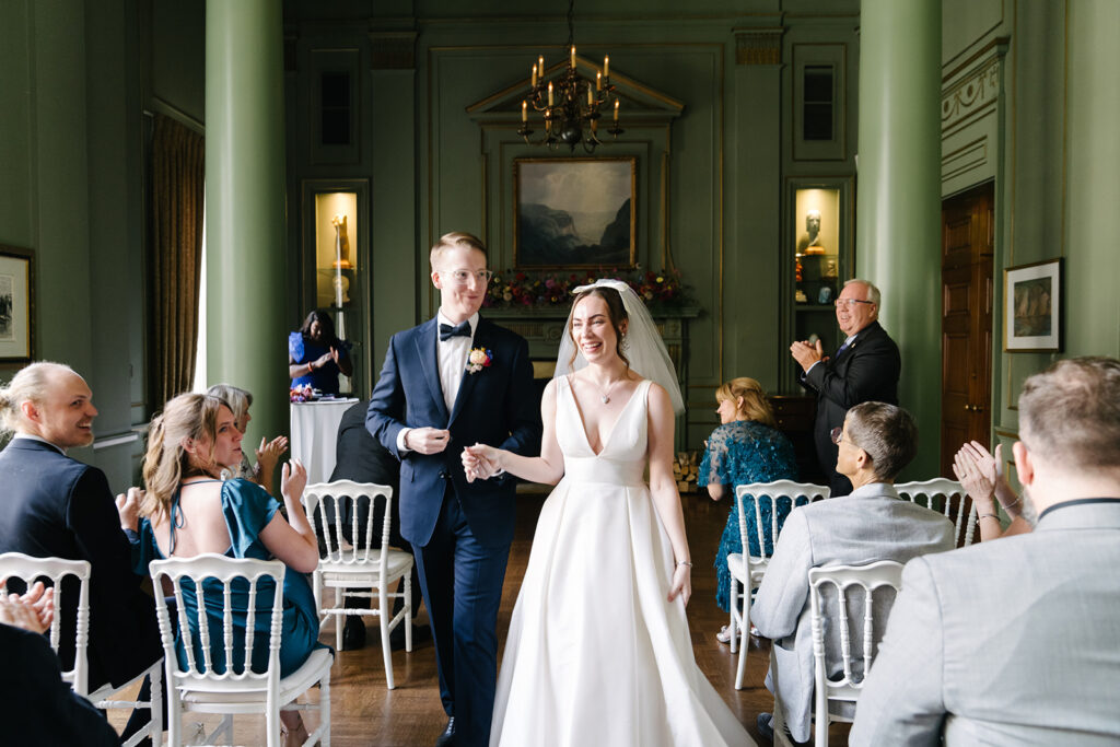 Ellie and Keith marry at the Toronto University Club. Ellie is wearing her tea-length wedding dress from Lea-Ann Belter Bridal