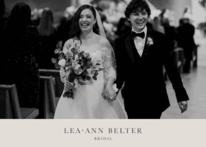 Newlyweds Madison and Kyle walk up the aisle smiling, with Madison in a lace bridal bolero and veil, holding a bouquet.