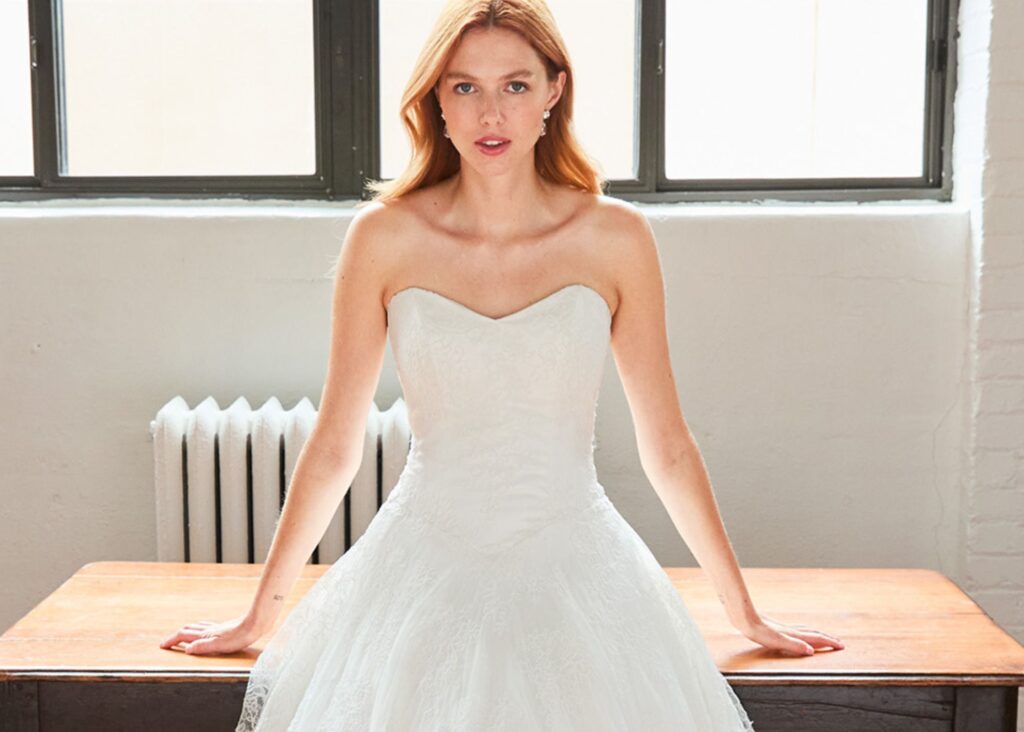 Lace basque waist wedding dress with strapless sweetheart neckline and full skirt
