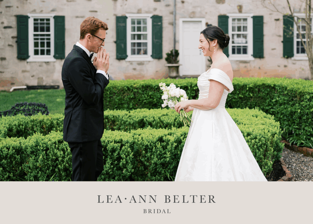 Emotional first look moment with bride in off-shoulder ballgown and groom in black tuxedo at The Appleford Estate, with historic stone building and manicured gardens in background
