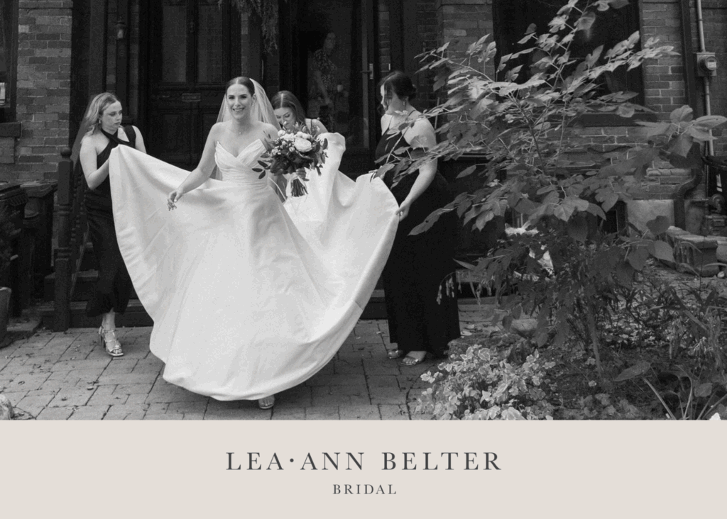 Natalie in her custom Lea-Ann Belter wedding gown outside The Broadview Hotel, surrounded by bridesmaids before the ceremony