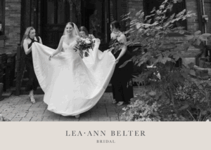 Natalie in her custom Lea-Ann Belter wedding gown outside The Broadview Hotel, surrounded by bridesmaids before the ceremony
