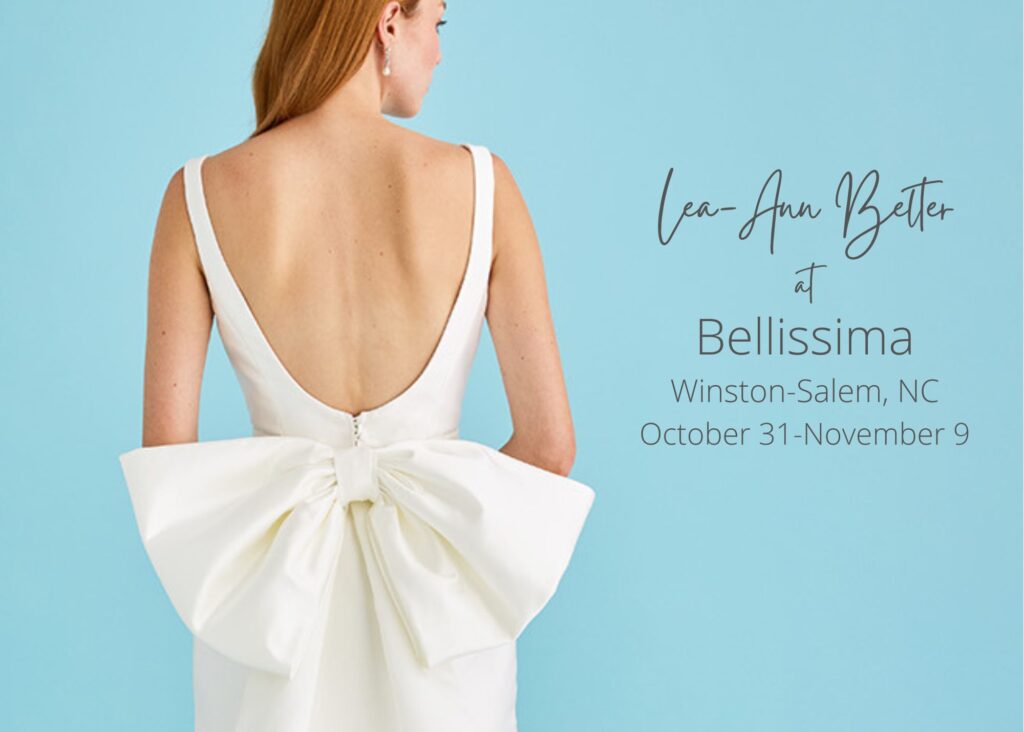 Back view of bride in sleeveless wedding dress with deep V-back and oversized bow detail at lower back by Lea-Ann Belter Bridal Toronto