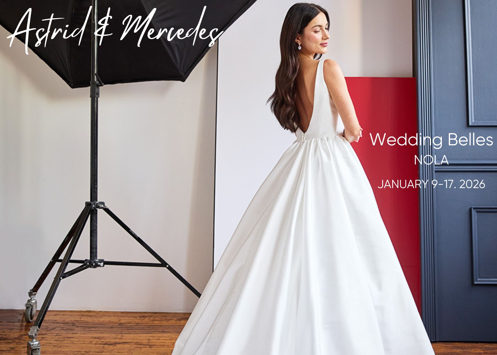 A bride stands in a modern photography studio, the train of her Astird & Mercedes ball gown wedding dress spread behind her. Text announces, trunk show in New Orleans, January 9-17 2026