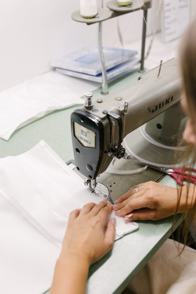 A craftsperson sews a wedding dress at Canadian bridal designer Lea-Ann Belter