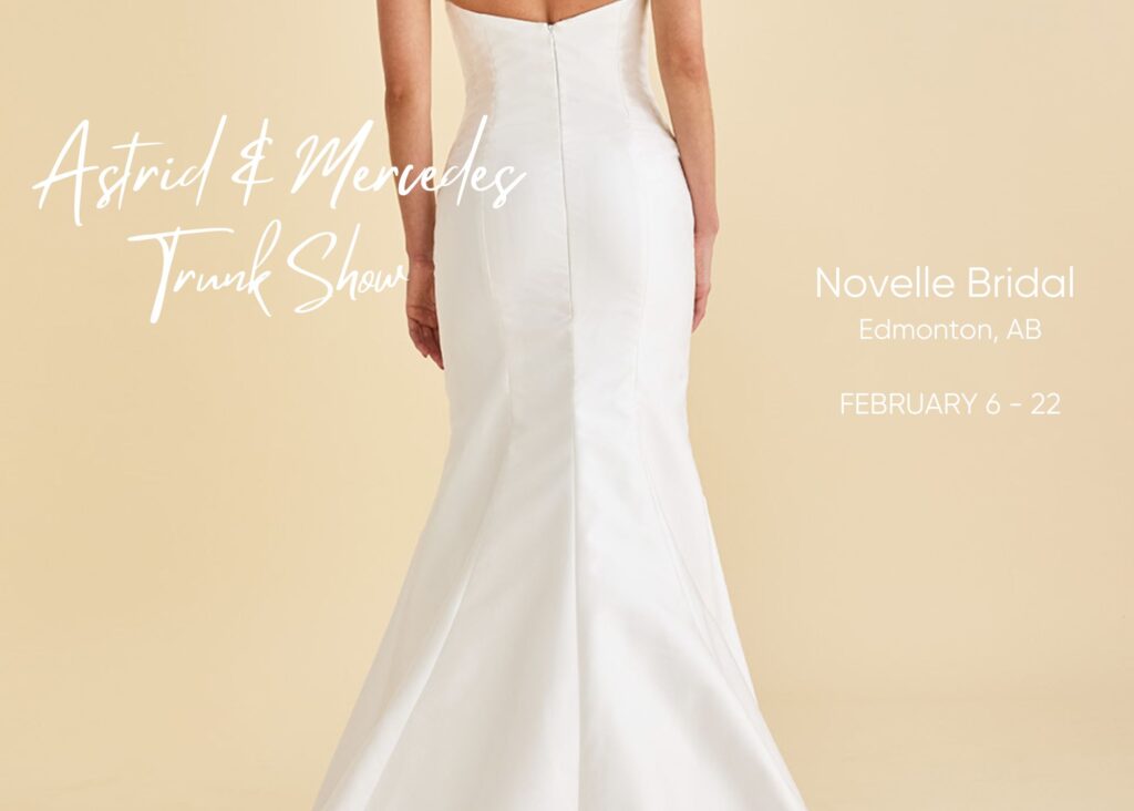 A bride models a sleek, architectural fit and flare wedding dress on a warm neutral backdrop. Text reads: Astrid & Mercedes Soirée Trunk Show at Novelle Bridal, February 6-22.
