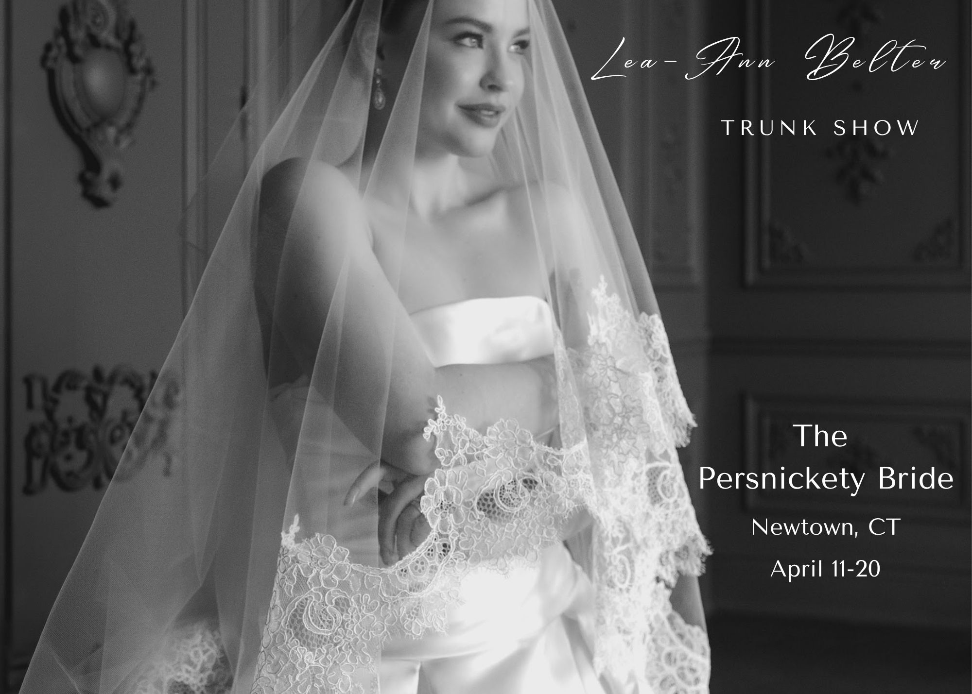 A close up of a bride wearing a classic drop waist ball gown and lace edged cathedral veil in black and white. Text reads - Lea-Ann Belter Keepsake collection trunk show, April 11-20 at Persnickety Bride in Newtown, Connecticut