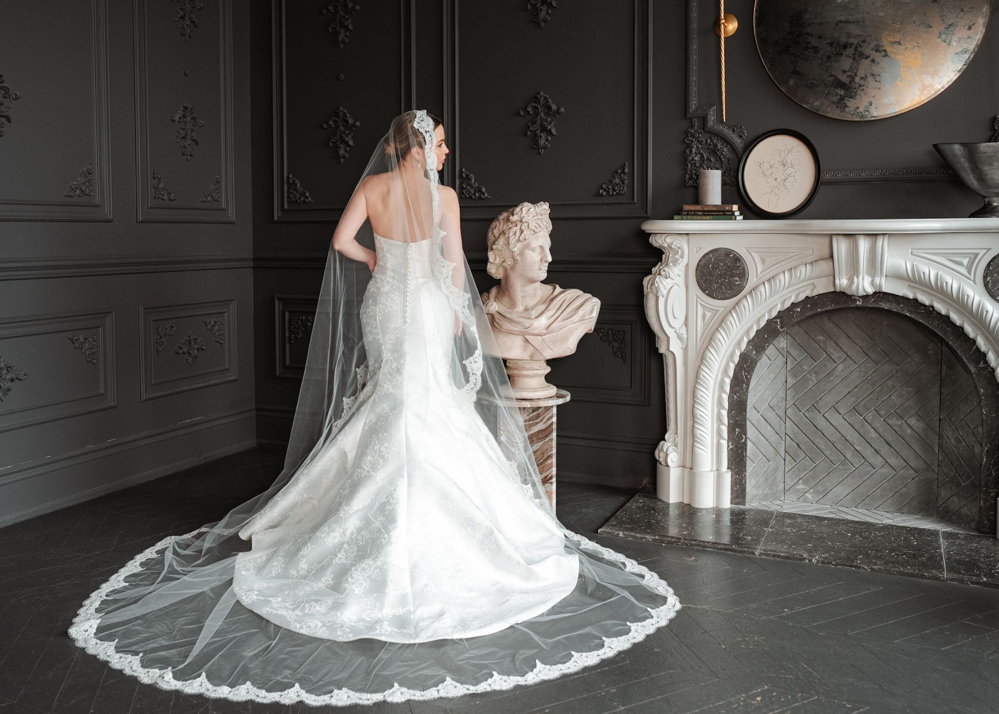 Nicole, an embroidered Mikado fit-and-flare wedding gown by Lea-Ann Belter Bridal, styled with a lace-edged cathedral veil