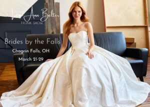 Lea-Ann Belter Bridal trunk show promotional image featuring a model in a ball gown with text reading: Brides by the Falls, Chagrin Falls, OH, March 21–29