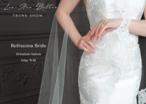 A close up of the embroidery on a form-fitting gown set on a dark background. Text atop the image reads, Lea Ann Belter Keepsake collection trunk show Bellissima Bride, Winston-Salem, NC, May 9-16