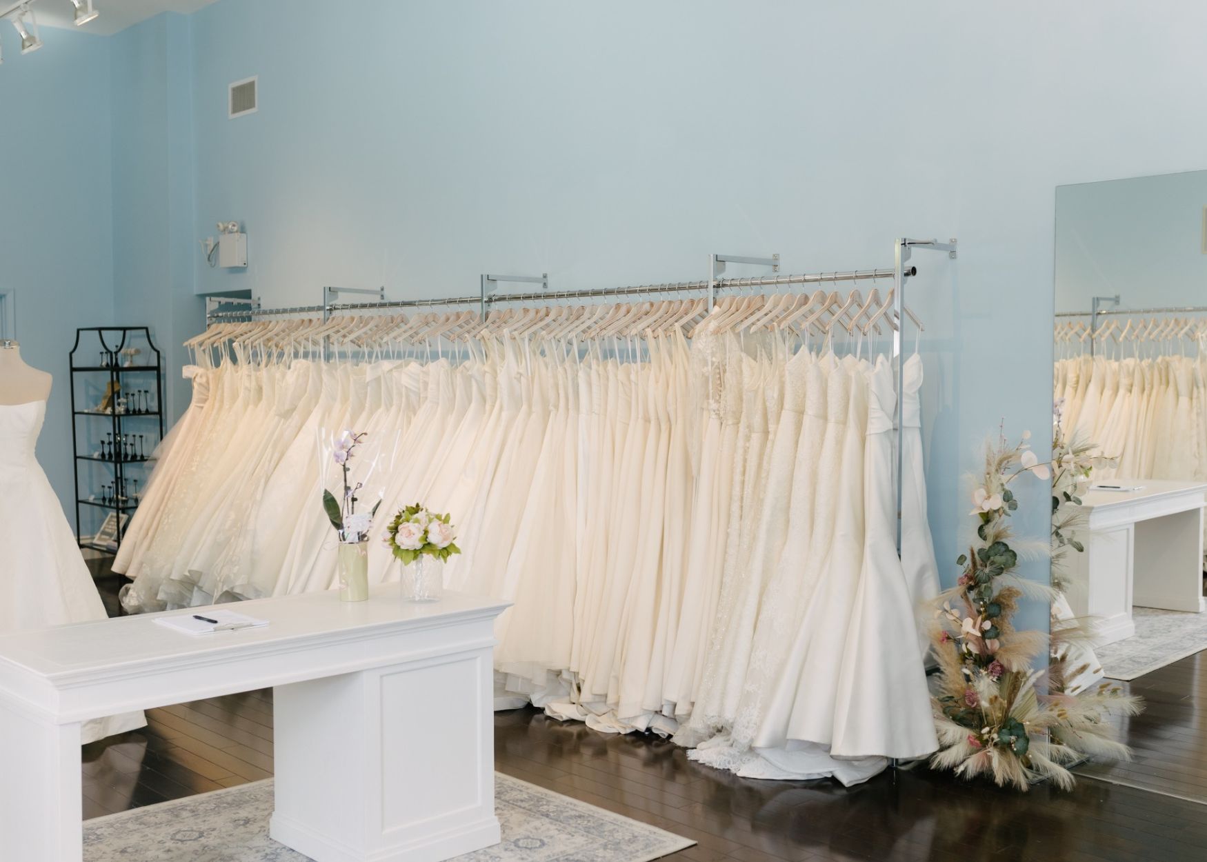 the airy blue interior of the Lea-Ann Belter flagship Toronto bridal store, displaying wedding dresses show at bridal trunk show