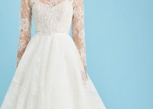 Lace wedding dress with sweetheart neckline, long sheer lace sleeves, and full lace ball gown skirt