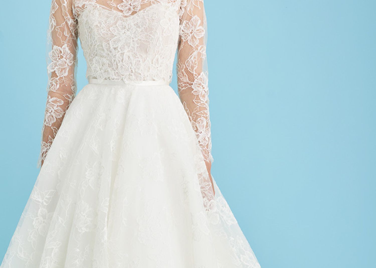 Lace wedding dress with sweetheart neckline, long sheer lace sleeves, and full lace ball gown skirt